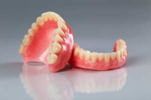Pair of dentures showcased on a glossy surface