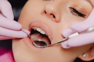 Dentist examining woman’s mouth