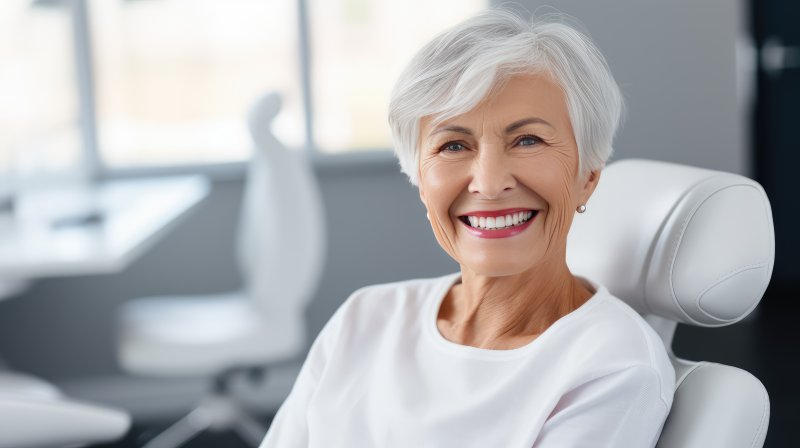 an older woman smiling with dental implants